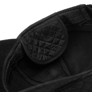 Detailed macro view of black winter cap's quilted inner lining and elastic strap