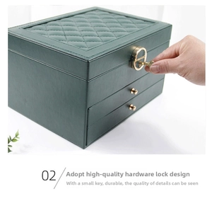 Detailed view of dark green leather jewelry box with golden lock and key system