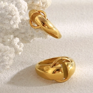 Minimalist 18K gold plated stainless steel interlocking ring on coral stone base