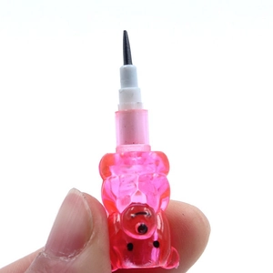 Pink bear-shaped stackable pencil refill with sharp tip shown in a hand macro shot
