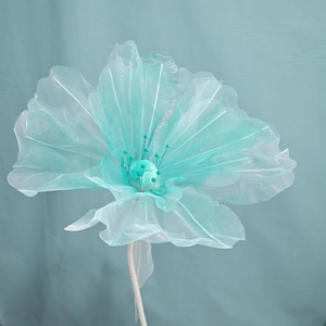 Detail of turquoise organza wedding flower with textured petals and beaded stamen