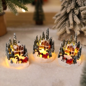 Set of three glowing Christmas village resin houses with warm lights for holiday decoration