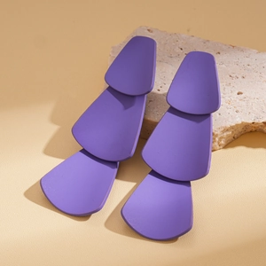 Detail of purple geometric layered tassel earrings with a matte finish and modern style