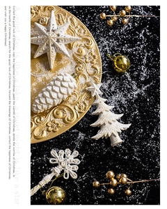 White pine cone and star ornaments in a gold tray with a festive winter theme