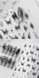 Detailed view of ink wash butterfly nail stickers with starburst and calligraphy patterns