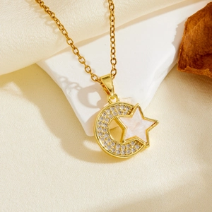 Artistic display of gold star and crescent moon necklace with sparkling crystals and inlay