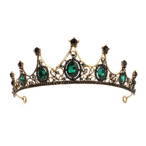 Detail of vintage gold bridal crown featuring deep green gemstones and black crystals