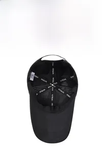 Detailed interior of a black baseball cap showing breathable mesh and branded inner tapes
