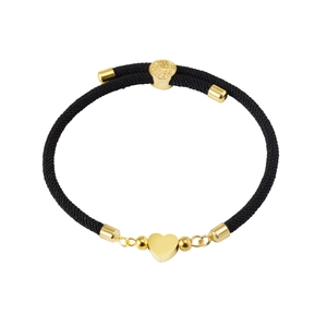 Close-up of black braided cord bracelet featuring polished gold heart pendant and beads