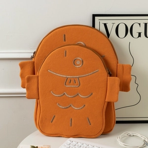 Detail view of cute orange fish-shaped padded laptop sleeves in two sizes on a white desk