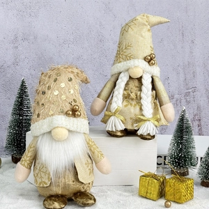 Pair of festive Christmas gnomes in warm gold and cream with snowflake knit details