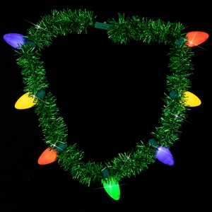 Close-up of a heart-shaped green tinsel necklace with glowing colorful LED light bulbs