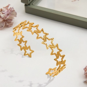 Elegant gold-tone open star bangle with alternating solid matte and hollow star motifs