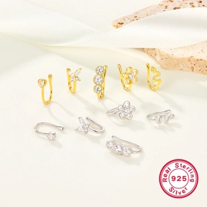 Detail of 925 sterling silver nose cuffs with zircon in heart and snake shapes