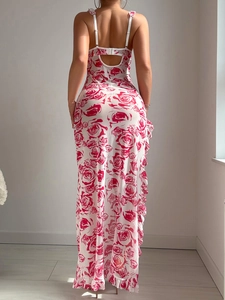 Detail of floral backless slip dress featuring red rose print and ruffles