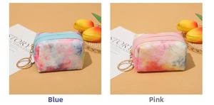 Macro detail of plush tie-dye star coin purses with gold zippers and keychains