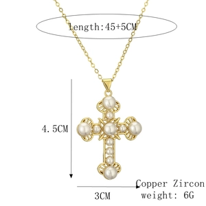Detail showing cross pendant dimensions 4.5cm by 3cm with pearls and zircon in gold finish