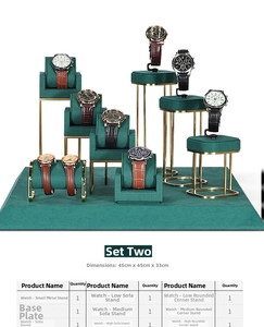 Green velvet and gold metal watch display stand set including various tiered holders