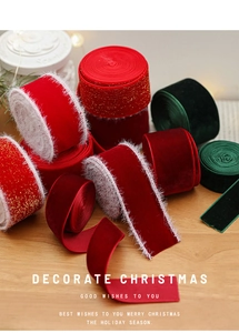 Close-up of luxury red velvet Christmas ribbons with white edges and gold glitter finish
