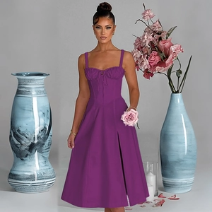 Detail of a purple spaghetti strap dress with a slim fit corset waist and high side slit