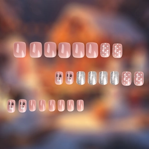 Christmas press-on nails set with 24 pink glitter pieces featuring reindeer and dot art