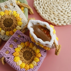 Handmade crochet sunflower drawstring mini pouch made of soft wool yarn in purple