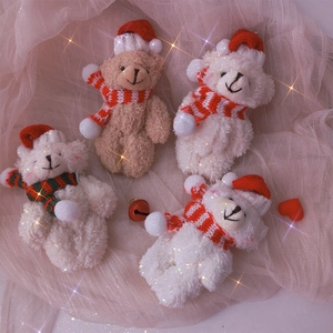 Detail view of four cute plush Christmas bears with hats and scarves on pink tulle