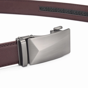 Macro shot of a brushed metal automatic buckle and textured leather ratchet belt strap