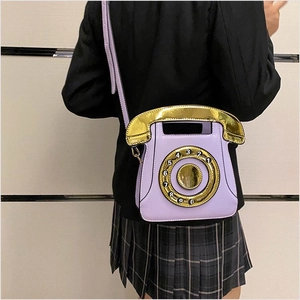 Creative purple telephone shaped crossbody bag with gold sequin dial detail shown on model