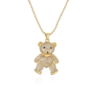 Golden teddy bear pendant necklace with white zircons and heart detail on bead chain