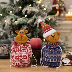 Charming knitted Christmas drawstring gift bags featuring plush reindeer and bear decorations