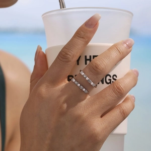 Slim stainless steel adjustable ring with pearls and zircons worn on model's finger