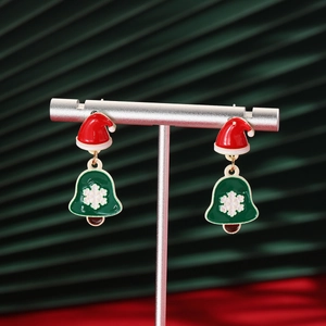 Detailed shot of Christmas hat and snowflake bell earrings on silver display stand