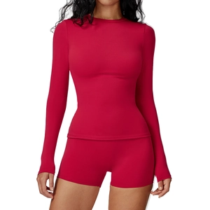 Women's slim fit red yoga set with long sleeve crew neck top and high waist sports shorts