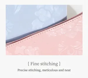 Detail of floral embossed PU leather pouch with precise stitching and contrast zipper