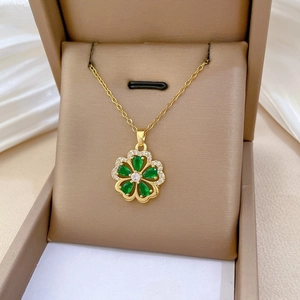 Close-up of green five-leaf flower pendant necklace with diamonds in a jewelry box