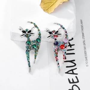 Set of two vintage cat brooches with vibrant rhinestones and elegant silver alloy curves