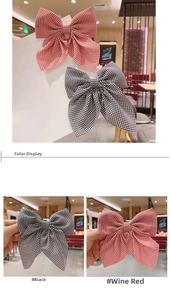 Detail showing burgundy and black plaid bow hair clips in a lifestyle cafe setting