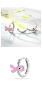 Detailed close-up of pink enamel ribbon bow huggie earrings with silver finish