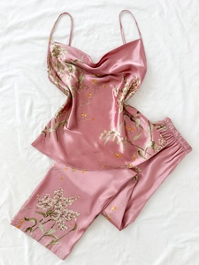 Dettaglio del set pigiama in raso rosa con stampa floreale e top con scollo a cappuccio