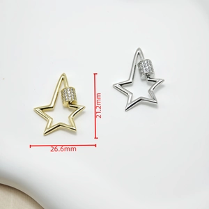 Detail of star-shaped zircon screw clasps in gold and silver showing 26.6mm dimensions