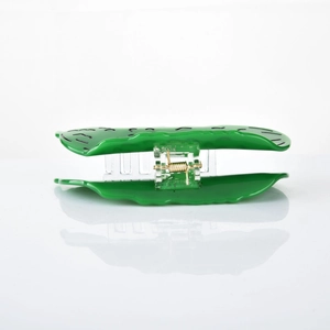Detail of green leaf-shaped hair claw clip with black striped texture and golden spring