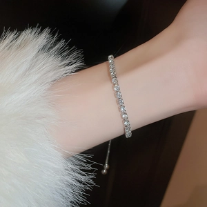 Detail of silver tennis bracelet with cubic zirconia and adjustable slider bead clasp