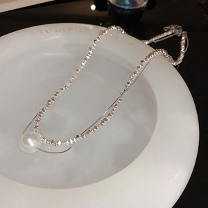 Elegant double-layered silver chain necklace featuring crushed silver beads and a large white pearl
