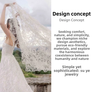 Detail of elegant white floral lace bridal headpiece with intricate mesh embroidery pattern