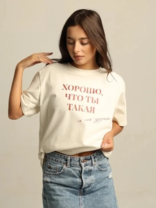 Detailed view of red Russian lettering print on beige cotton t-shirt with a round neck