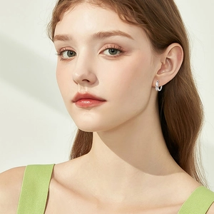 Elegant S925 sterling silver leaf hoop earrings with moissanite pavé on female model