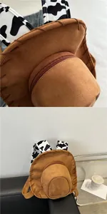 Detail of brown cowboy hat backpack with cow print straps and contrast stitching
