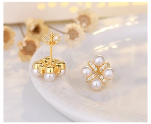 Macro view of gold flower pearl earrings with fine micro-inlaid zircon detailing