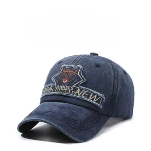 Macro detail of navy washed cotton baseball cap with wolf embroidery and vintage patches